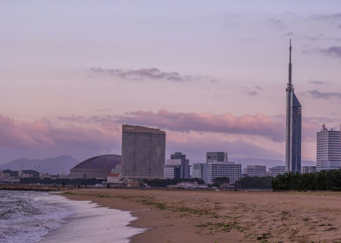 The beach of Momochi Seaside Park at sunset.